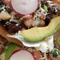 Two Sopes · Fluffy fried corn masa cakes topped with choice of meat, beans, lettuce, tomatoes, cheese an...