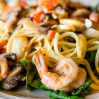 Shrimp Scampi · Succulent shrimp and mushrooms cooked in a garlic, butter and wine sauce, served our linguini.