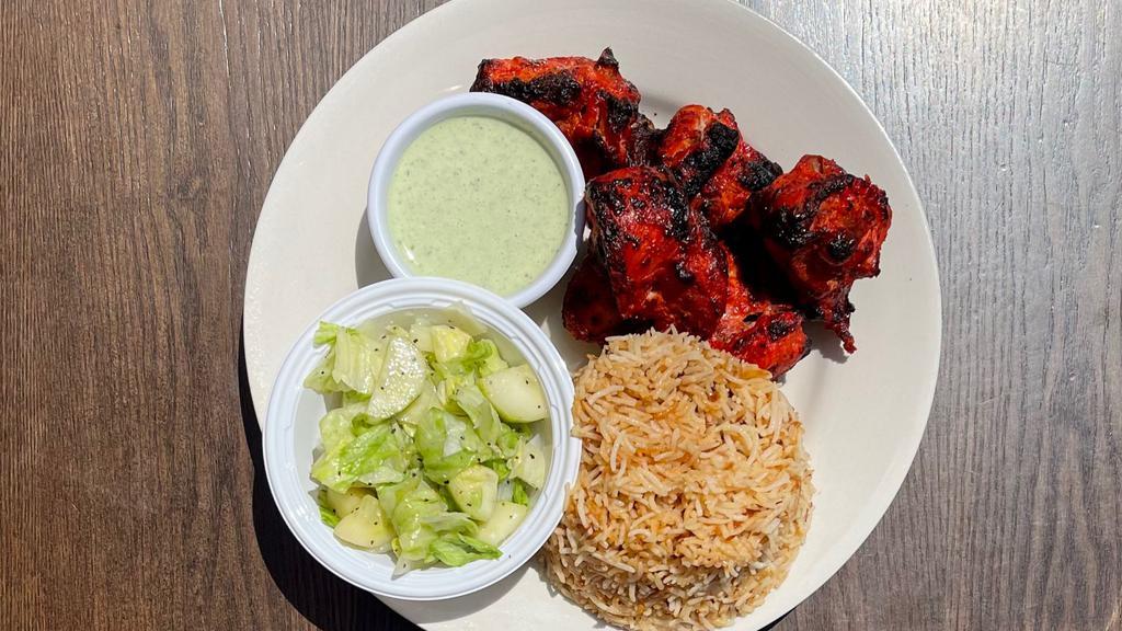 Chicken Tikka Platter · Chicken pieces baked using skewers in Tandoor Oven, marinated in yogurt, onion, spices and sauce. Served with Side of Mint Sauce, Salad and Choice of Rice or Naan Bread.