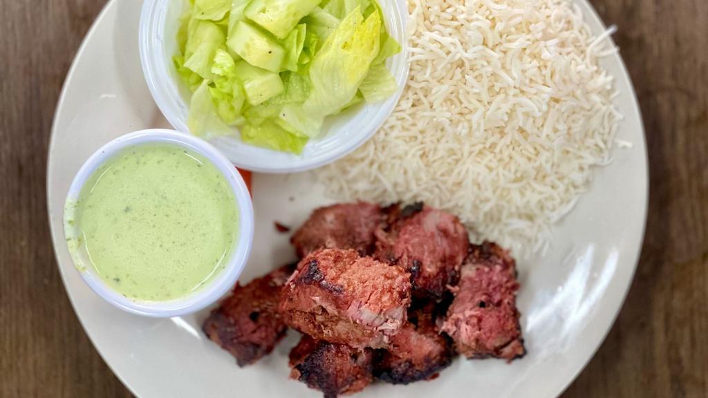 Beef Boti Kabab · Cubes of beef marinated with the regular spices, yogurt, papaya paste and ginger garlic paste. Served with Side of Mint Sauce, Salad and Choice of Rice or Naan Bread.