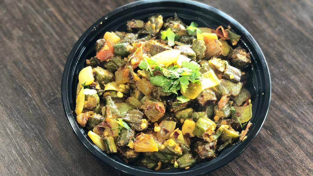 Bhindi (Okra) · Fried Okra cooked to perfection with green chili, onions and herbs.