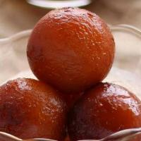 Gulab Jaman (1Lb) · Fried dough balls that are soaked in a sweet, sticky Rose Flavor Sugar syrup.