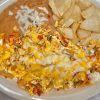 Chilaquiles Plate · 3 eggs scrambled with grilled pico de gallo, fried tortilla strips, and topped with melted y...