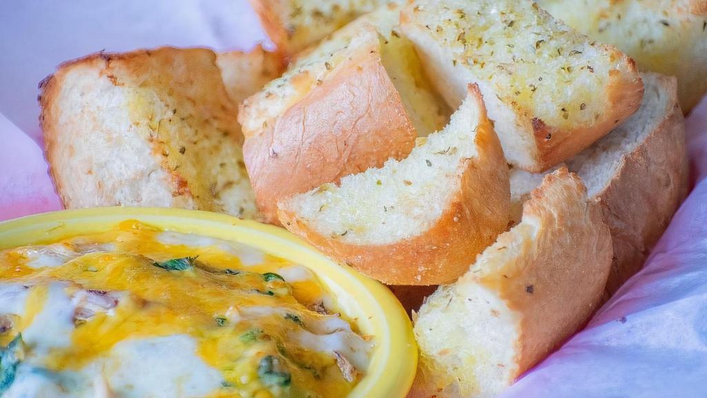 Crab Dog Dip · House-made crab dip with crab meat, spinach, melted cheddar, parmesan, and mozzarella cheese. Served with toasted garlic bread.