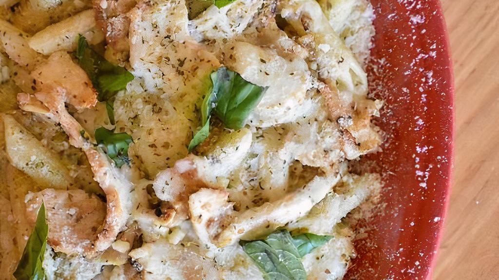 Baked Chicken Pesto · Sliced chicken breast and penne pasta tossed in our creamy pesto alfredo sauce topped with mozzarella and fresh basil.