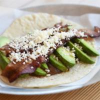 Bada Boom! · Spiced black bean puree, thick and crispy applewood smoked bacon, avocado wedges, queso fres...