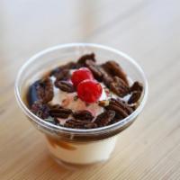 Turtle · Creamy vanilla custard topped with rich hot fudge, caramel and roasted pecans.