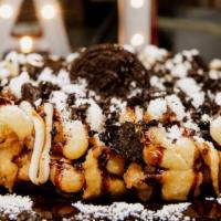 Oreo Cookie Funnel Cake · Freshly prepared funnel cake, sprinkled with powdered sugar, cream cheese drizzle, crumbled ...