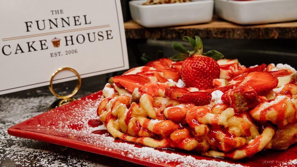 Strawberry Funnel Cake · Freshly prepared funnel cake, sprinkled with powdered and topped with freshly sliced strawberries topped with  Strawberry Puree’.