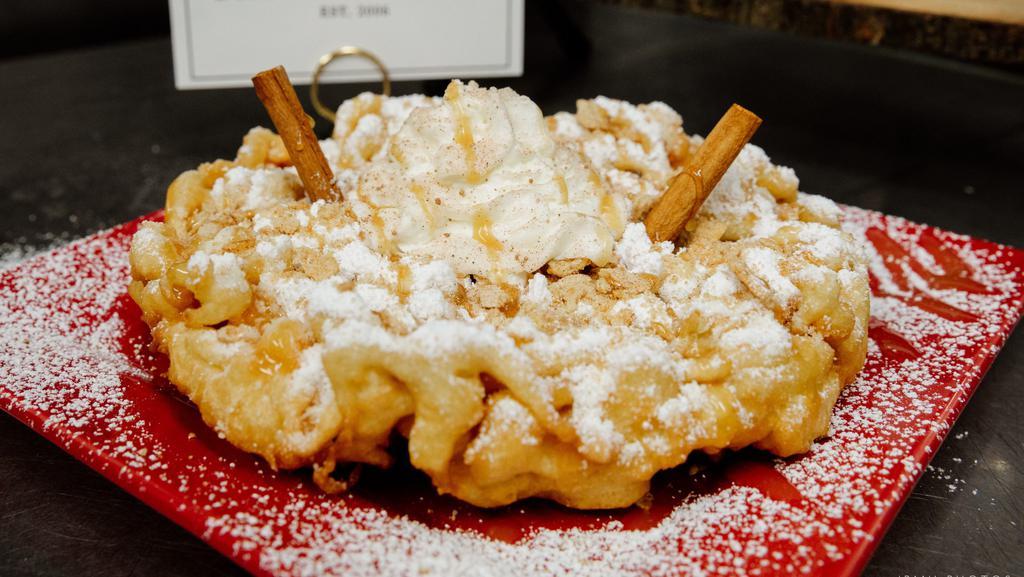 Cinnamon Toast Crunch Funnel Cake · Crushed cinnamon toast crunch our signature cinnamon whipped cream topped with caramel drizzle and garnished with fresh cinnamon sticks.