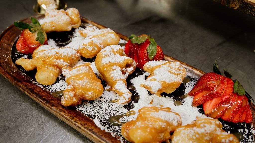 Funnel Cake Bites · Our delicious funnel cake batter but bite sized. Served with your choice of  dipping sauce.