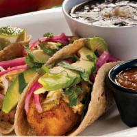 Baja Beer-Battered Fish Soft Tacos · Chipotle Slaw, Avocado, Marinated Red Onions, Cilantro, Salsa. Served with Black Beans & Lim...
