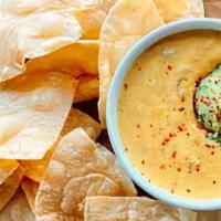Chi'Jeu Queso And Chips · Green chile queso with crispy corn tortilla chips