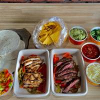 Family Style Fajita Dinner · grilled chicken and steak with sauteed peppers and onions,. served with refried beans, mexic...