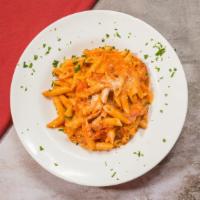 Penne Ala Vodka · Marinara cream sauce with spicy vodka tossed with ground bacon and penne pasta. Served with ...
