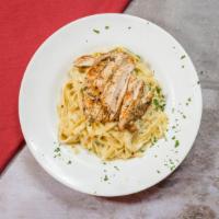 Fettuccine Alfredo · Egg noodles pasta in a Parmesan cream sauce and nutmeg. Served with a cup of minestrone soup...