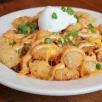 Loaded Bacon Tater Tots (D) · Crispy tater tots topped with bacon/cheddar cheese/green onion/house-made chipotle mayo /sou...