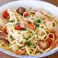 Seafood Scampi · Sautéed shrimp, scallops, slow-roasted tomatoes, garlic butter, linguine