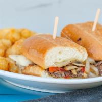 Philly Cheesesteak · Thinly sliced rib-eye steak, grilled peppers, caramelized onions, sautéed mushrooms topped w...