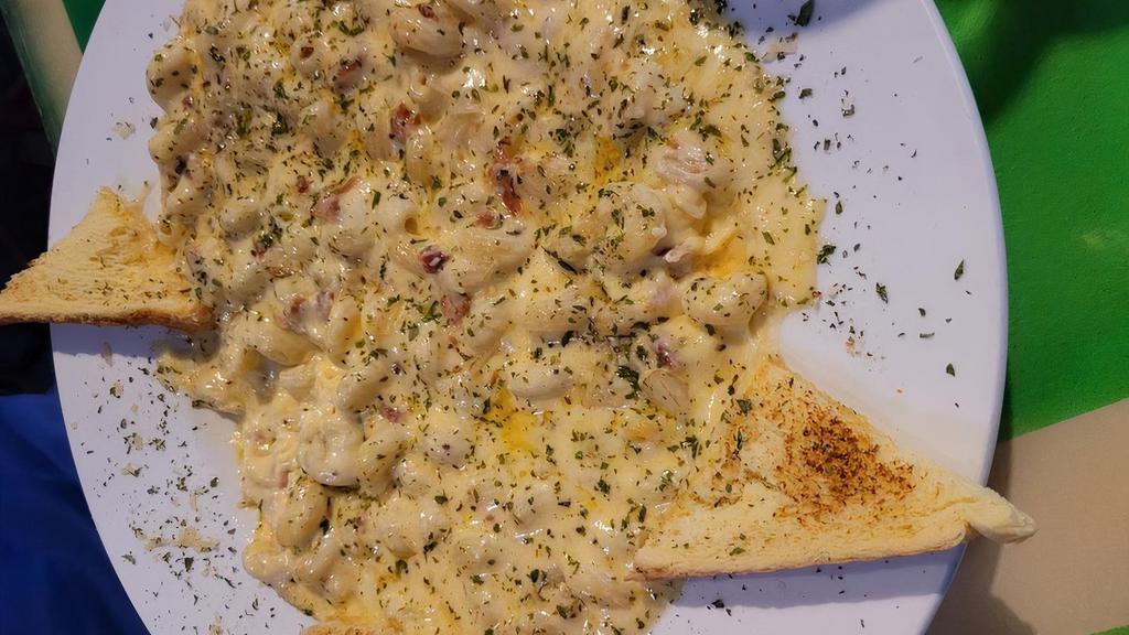 Mac & Cheese · Our house made cheese sauce over penne pasta, topped with bread crumbs and garlic toast.