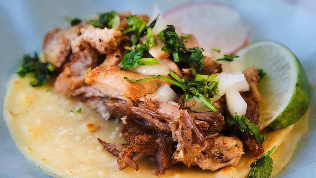 Carnitas · Pork simmered in water and spices until tender, then shredded
