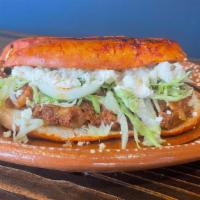 Pambazo · Mexican chorizo with potatoes, lettuce, onions, Mexican cream, queso fresco on a roll covere...