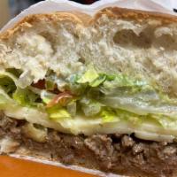 Torta · A traditional Mexican sandwich made with carne asada, refried beans, cheese, lettuce, tomato...