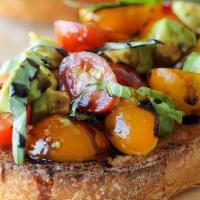 Avocado Bruschetta · Grilled Sourdough with mixed heirloom tomatoes Topped with chefs Mazaro infusion.