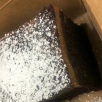 Triple Choco Flan · Creamy thin layer of flan on top of a decadent triple chocolate cake lightly dusted with pow...
