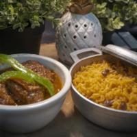 Carne Guisada · Beef Stew made Caribbean Style served with the choice of rice, beans, and two tostones.
