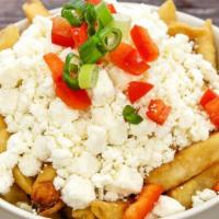 Feta Fries · Crispy fries topped with crumbled feta cheese, scallions, Mediterranean herbs & spices, driz...