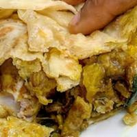 Veggie Roti  · Curried Pumpkin, Potatoes & Chickpeas wrapped in a Dhal Puri Roti.