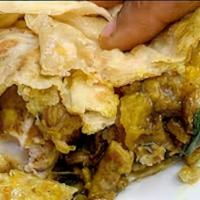 Shrimp Roti · Curried Shrimp, Potatoes & Chickpeas wrapped in a Dhal Puri Roti.