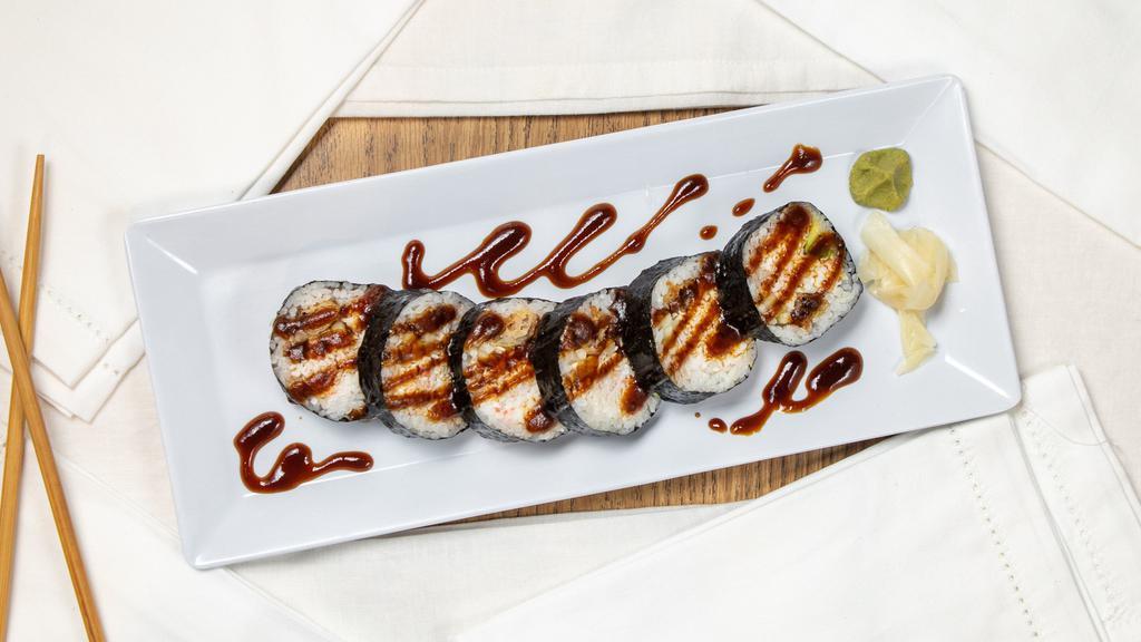 Spider Roll · Deep-fried soft shell crab, crab meat, cucumber, and avocado topped with eel sauce and seaweed outside.