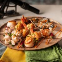 Sandy Bay Seafood Platter · Sautéed shrimp and scallops on fragrant South African rice, wood-grilled calamari and trinch...