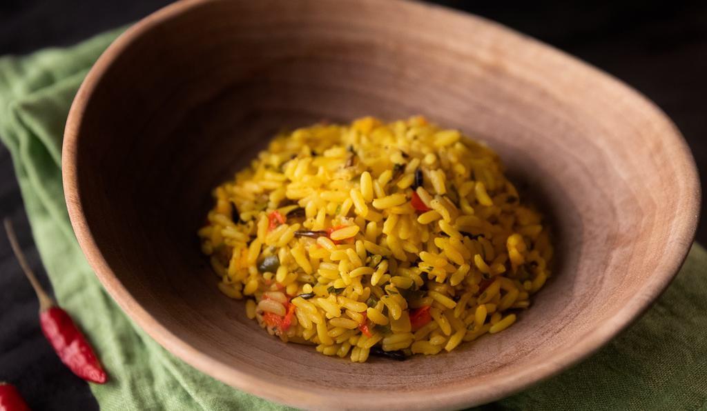 Fragrant Rice · South African-style long grain and wild rice with corn, bell peppers, cilantro and onions seasoned with turmeric and South African herbs.