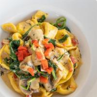 Tortelloni Primavera · Spinach, tomato, mushroom, onion, roasted red pepper, Caribbean herbs, Alfredo and cheese to...