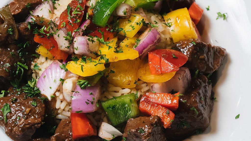 Pepper Steak · Tenderloin beef tips simmered in beef stock with bell peppers. Served over rice. Served with one side dish