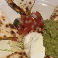 Chicken Quesadilla Al Carbon · Two fresh flour tortillas stuffed with Monterey Jack and Cheddar cheese. Served with lettuce...