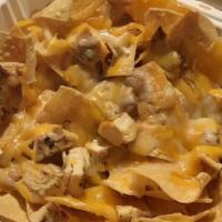Grilled Chicken Nachos · Tortilla chips covered with melted cheese, pinto beans, guacamole, sour cream, and pico de g...