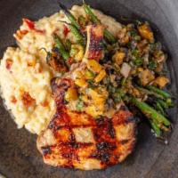 Frenched Pork Chop · Brined Pork Chop, Sundried Tomato Risotto, Grilled Green Beans, and Spicy Pineapple Salsa. 
...