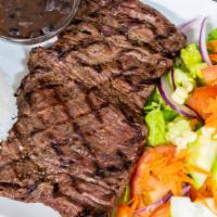 Carne Asada · Grilled steak served with rice, beans, salad, aguacate, queso fresco, and tortilla.