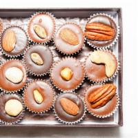 Nuts About Nuts Sampler · Twelve pieces. Assortment of nuts in our gourmet milk and dark chocolate. Each box may inclu...