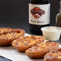 Potato Skins · Unpeeled potato halves hollowed and dressed with bacon, Cheddar cheese, served with sour cre...