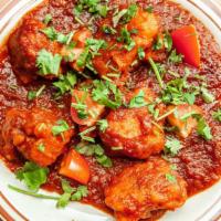 Gobi Manchurian · Cauliflower in sweet & sour sauce with onions and tomatoes.