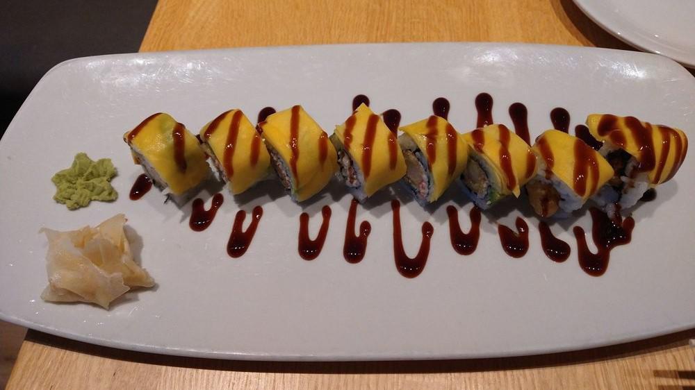 Mango Roll (8 Pc) · Shrimp tempura and crab layered with avocado and mango and drizzled with unagi sauce.