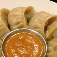 Chicken Momo · Steamed dumplings filled with minced chicken and momo spices.