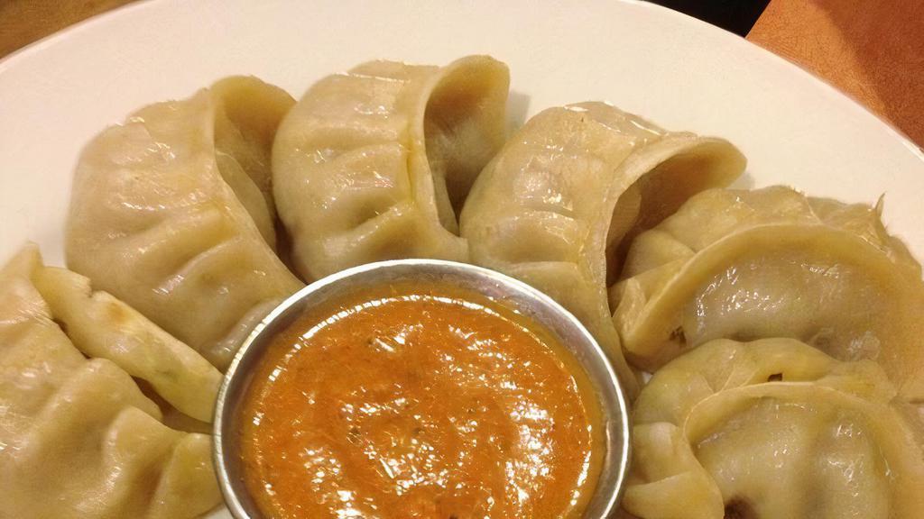 Chicken Momo · Steamed dumplings filled with minced chicken and momo spices.