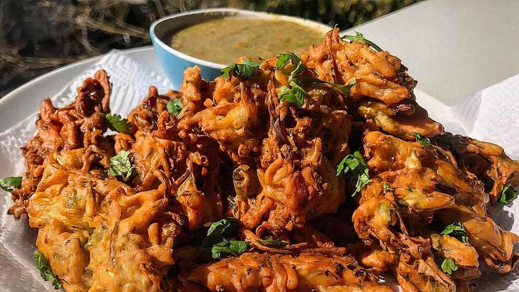 Veg Pakora (6 Pieces) · Spicy fritter made of potatoes and onions, coated in spiced gram flour and deep-fried until golden brown.