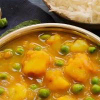 Aloo Mutter (Vegan) · Green peas and potato cooked in tomato and onion based sauce seasoned with Indian spices.